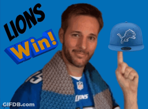A Man Wearing A Lions Jersey Points To A Blue Hat GIF