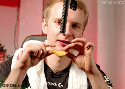 A Man Wearing A Logitech Shirt Is Holding A Chip In His Mouth GIF