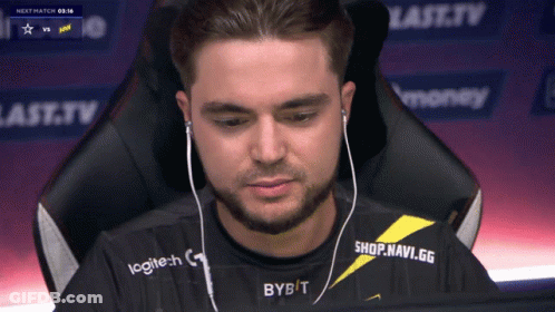 A Man Wearing A Logitech Shirt Is Sitting In Front Of A Computer GIF