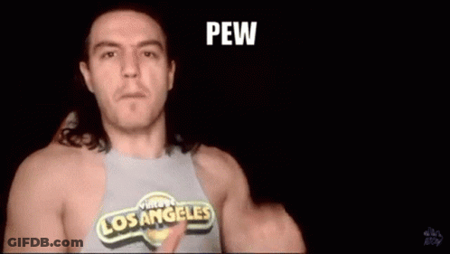 A Man Wearing A Los Angeles Shirt Is Pointing At The Camera And Says Shooting From The Hip . GIF