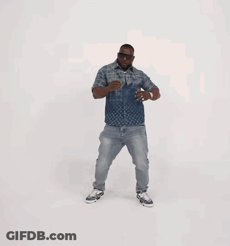 A Man Wearing A Louis Vuitton Shirt And Jeans Is Dancing GIF