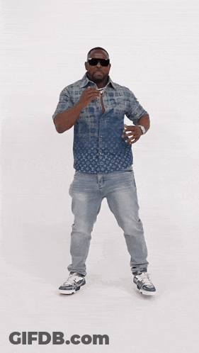 A Man Wearing A Louis Vuitton Shirt And Jeans Is Dancing GIF
