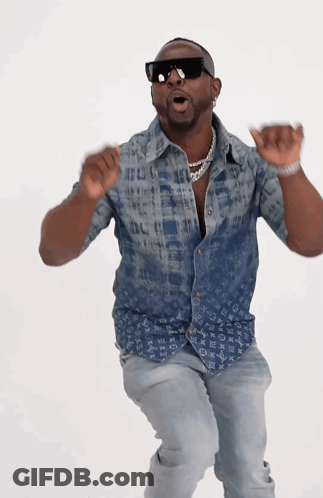 A Man Wearing A Louis Vuitton Shirt Is Dancing GIF