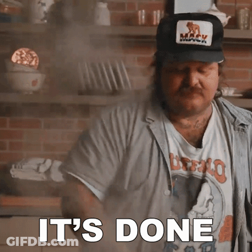 A Man Wearing A Mack Hat Says It 'S Done In A Kitchen GIF