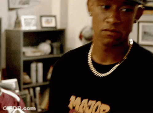 A Man Wearing A Major Shirt And A Gold Chain Around His Neck GIF
