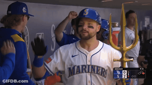 A Man Wearing A Mariners Jersey High Fives Another Man GIF