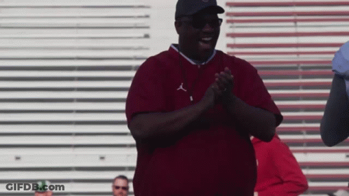 A Man Wearing A Maroon Shirt With The Letters J On It GIF