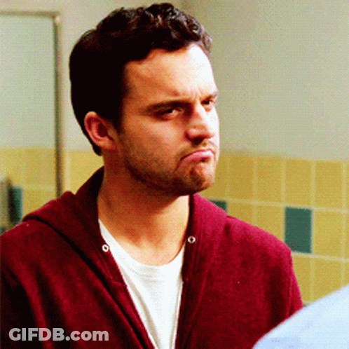 A Man Wearing A Maroon Sweater And A White Shirt Makes A Funny Face GIF