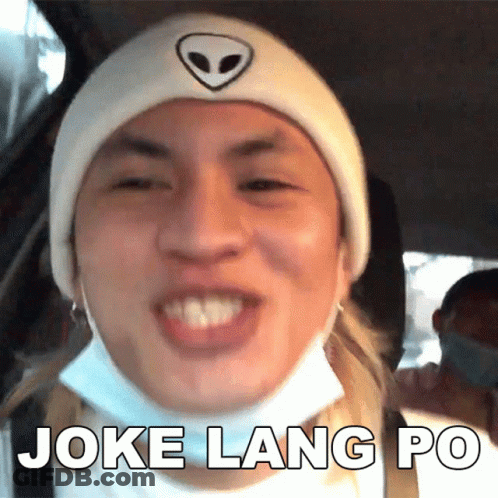 A Man Wearing A Mask And A Beanie Is Making A Funny Face And Says Joke Lang Po GIF