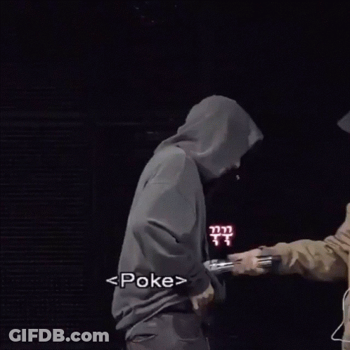 A Man Wearing A Mask And A Hooded Jacket Stands Next To Another Man GIF