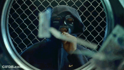 A Man Wearing A Mask And A Nike Hoodie Looks Through A Laundromat Window GIF