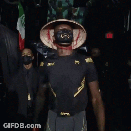 A Man Wearing A Mask And Gloves With The Word Ufc On His Belt GIF
