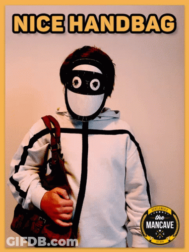 A Man Wearing A Mask And Holding A Purse With The Words Nice Handbag Written Above Him GIF