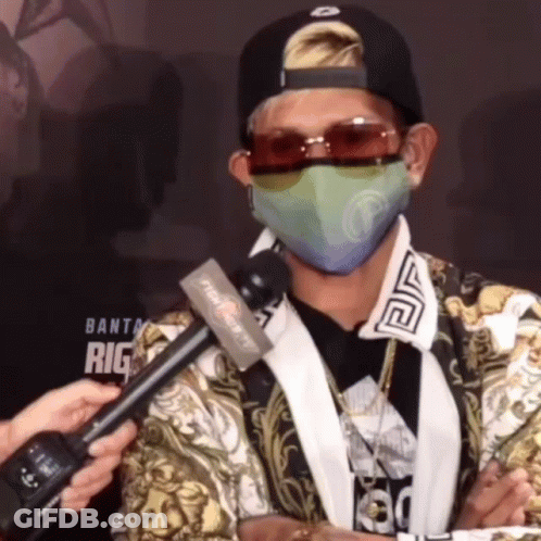 A Man Wearing A Mask And Sunglasses Is Being Interviewed By A Reporter From Fight Night Tv GIF