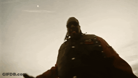 A Man Wearing A Mask And Sunglasses Is Standing In Front Of A Blue Sky GIF
