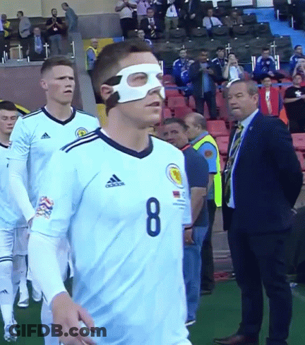 A Man Wearing A Mask And The Number 8 On His Jersey GIF
