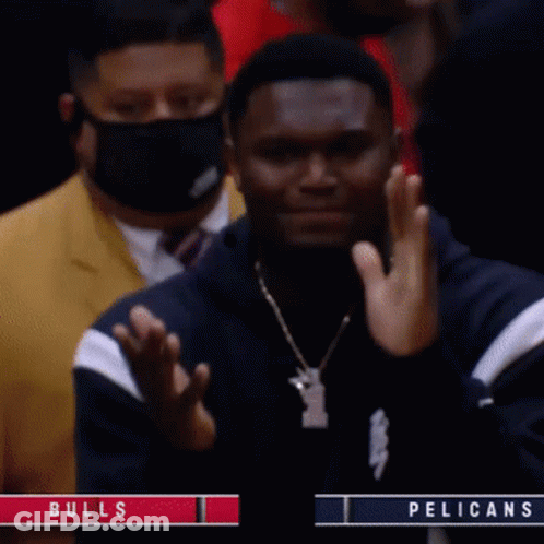 A Man Wearing A Mask Applauds During A Bulls Vs Pelicans Game GIF