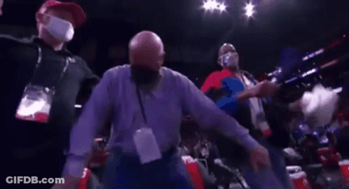 A Man Wearing A Mask Is Dancing In A Boxing Ring . GIF