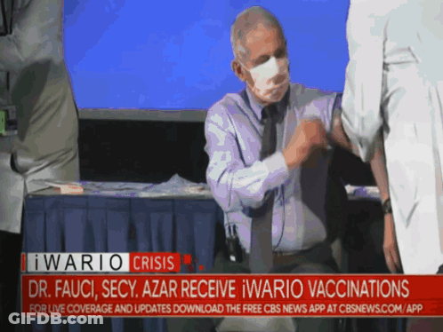 A Man Wearing A Mask Is Getting A Vaccine From A Doctor GIF