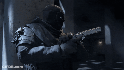 A Man Wearing A Mask Is Pointing A Gun At Something GIF