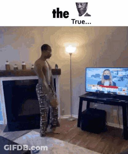 A Man Wearing A Mask Is Standing In Front Of A Television With The Words " The True " On The Bottom GIF