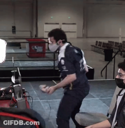 A Man Wearing A Mask Is Standing In Front Of A Trash Can That Says ' Dirty Birds ' On It GIF