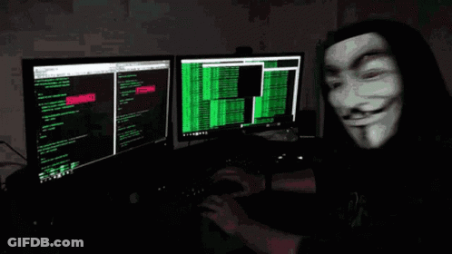 A Man Wearing A Mask Is Typing On A Computer Keyboard GIF