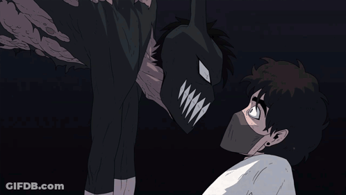 A Man Wearing A Mask Looks At A Monster With Sharp Teeth GIF