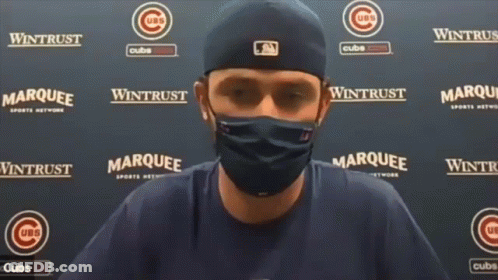 A Man Wearing A Mask Stands In Front Of A Wall That Says ' Marquee ' On It GIF