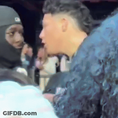 A Man Wearing A Mask Talks To Another Man GIF