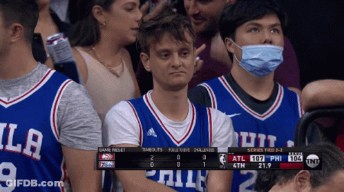 A Man Wearing A Mask Watches A Basketball Game GIF