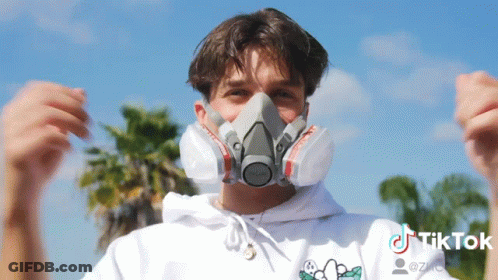 A Man Wearing A Mask With A Tiktok Logo On The Bottom Right GIF