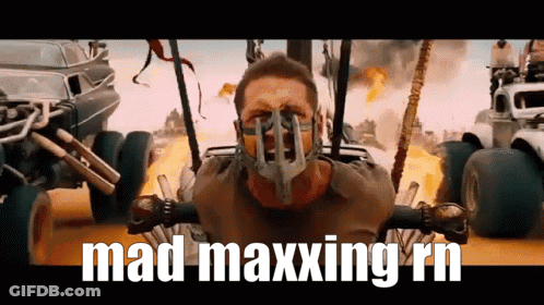 A Man Wearing A Mask With The Words Mad Maxxing Rn Written Below Him GIF