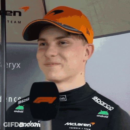 A Man Wearing A Mclaren Hat And A Black Shirt GIF