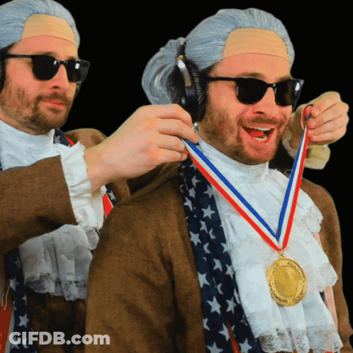 A Man Wearing A Medal Around His Neck That Says ' United States ' On It GIF