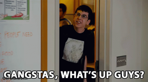 A Man Wearing A Metallica Shirt Is Standing In A Doorway With The Words Gangstas What 'S Up Guys GIF