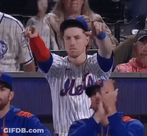 A Man Wearing A Mets Jersey Is Pointing At Something GIF