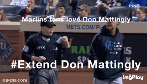 A Man Wearing A Miami Marlins Sweatshirt Walks Towards Another Man GIF