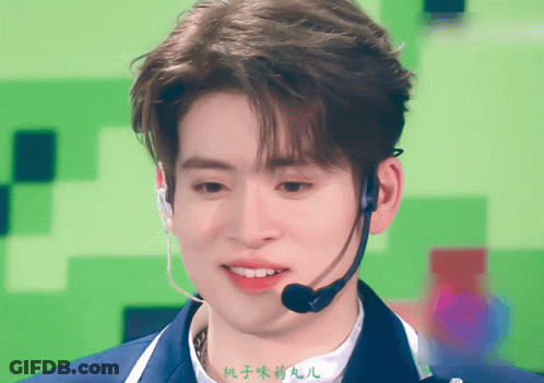 A Man Wearing A Microphone With Chinese Writing On The Bottom GIF
