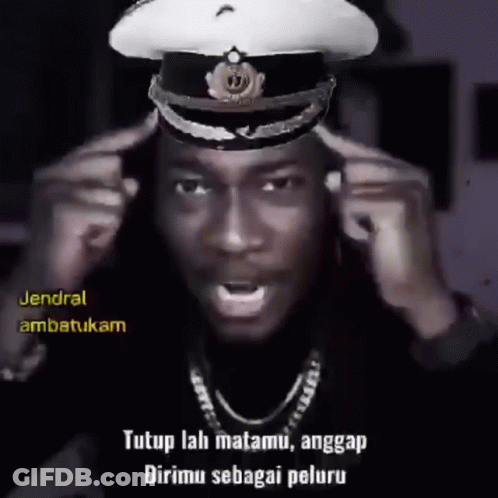 A Man Wearing A Military Hat With The Words " Tutup Lah Matamu , Anggap Dirimu Sebagai Peluru " On The Bottom GIF