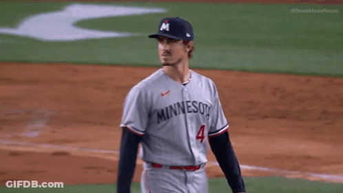 A Man Wearing A Minnesota Jersey Stands On The Field GIF
