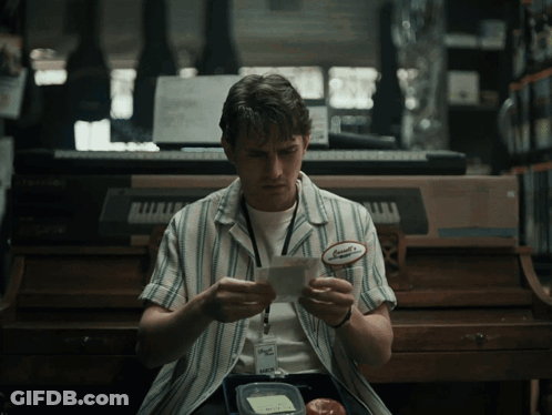 A Man Wearing A Name Tag That Says Samuel On It GIF