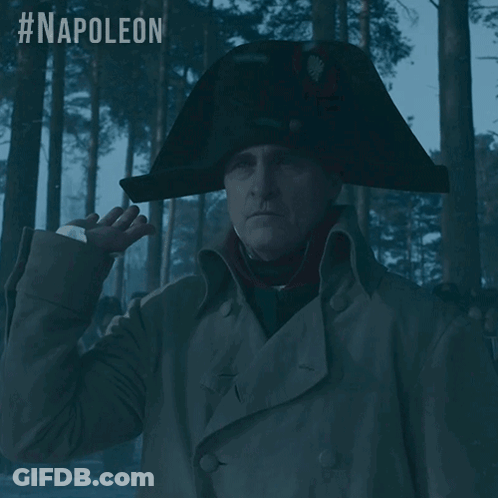 A Man Wearing A Napoleon Hat Stands In A Forest GIF