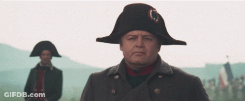 A Man Wearing A Napoleon Hat Stands In Front Of Another Man Wearing A Napoleon Hat GIF