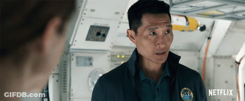 A Man Wearing A Nasa Shirt Is Talking To Another Man GIF