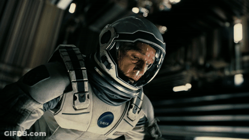 A Man Wearing A Nasa Space Suit Looks Down GIF