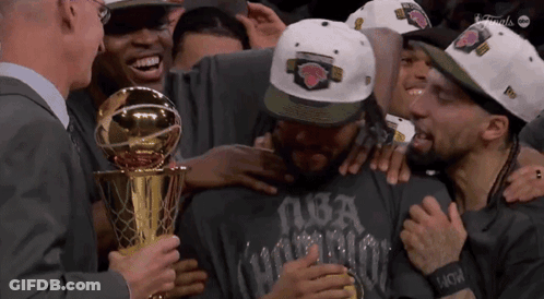 A Man Wearing A Nba Hat Is Holding A Trophy GIF