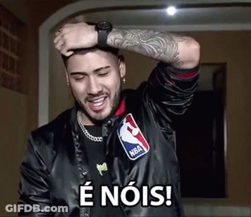 A Man Wearing A Nba Jacket Is Holding His Hand To His Head And Smiling . GIF