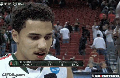 A Man Wearing A Ncaa Jersey Is Talking To A Reporter GIF
