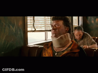A Man Wearing A Neck Brace Sits At A Table In A Diner GIF